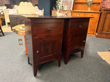 Load image into Gallery viewer, A charming pair of solid wooden bedside tables ready to bring warmth to your bedroom. Each piece features practical storage with a dovetail-jointed drawer and cupboard below, offering plenty of space for your essentials. Well-crafted and built to last, these pre-loved companions show character through their patina whilst remaining in excellent working order.
Overall Dimensions
47cm wide x 35cm deep x 71cm high
DELIVERY AVAILABLE
HAVE THIS PAINTED A COLOUR OF YOUR CHOICE FOR AN EXTRA £60 OR HAVE IT