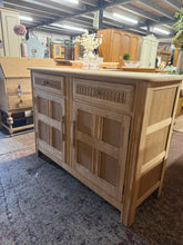 Load image into Gallery viewer, A beautiful Ercol sideboard stripped back to natural wood, revealing its classic mid-century charm. The piece features two short drawers positioned above a double cupboard with internal shelf storage—ideal for concealing household essentials. Being stripped, the wood may benefit from a protective coat of wax to enhance its finish and durability. A versatile addition to dining rooms or living spaces seeking authentic vintage character.
Delivery Available
Overall Dimensions
121cm wide x 45cm deep x 86cm hi