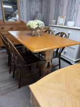 Load image into Gallery viewer, Oak dining table with stripped finish and varnished top. Natural wood legs ready for customisation with paint or stain. Seats 4–6 comfortably. Detachable legs for convenient transport and rearrangement. Minor surface mark adds character to this versatile piece. Ideal for those seeking authentic, adaptable furniture with genuine patina.
Delivery Available
Overall Dimensions
139cm long x 81cm wide x 75.5cm high