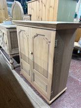 Load image into Gallery viewer, Characterful stripped oak cupboard with authentic patina from years of use. Features three removable shelves offering flexible storage solutions. The natural wood finish showcases the oak's grain and warmth—a light coat of wax will enhance protection and lustre. Ideal for displaying treasures or storing everyday essentials with timeless appeal.
Delivery Available
Overall Dimensions
93cm wide x 43cm deep x 103cm high