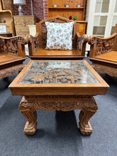 Load image into Gallery viewer, An eye-catching statement piece, this Chinese hardwood coffee table combines traditional craftsmanship with functional elegance. Structurally sound and built to last, it showcases intricate carved detailing throughout. The piece is pre-loved with subtle patina marks that add character to any living space. Topped with a protective glass surface, it's both practical and distinctive—perfect for adding warmth and cultural richness to your home.
Delivery Available
Overall Dimensions
51.5cm wide x 51.5cm deep