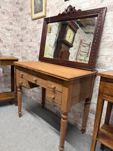 Load image into Gallery viewer, Stripped mahogany desk with natural wood grain exposed. Features five practical drawers—four short and one long—ideal for organised storage. The piece shows genuine character with minor surface marks consistent with vintage furniture. Handles display age-related wear but remain fully functional. Bare wood finish allows you to personalise with wax or oil to suit your décor.
Delivery Available
Overall Dimensions
86cm wide x 51cm deep x 78cm high