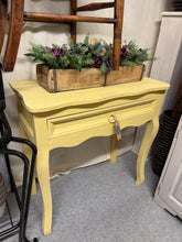 Load image into Gallery viewer, This solid wooden hall table showcases a stunning Farrow & Ball 'Sudbury Yellow' finish that brings warmth and character to any entryway. Structurally sound and well-maintained, it bears the gentle patina of gentle use but nothing major at all.
Delivery Available
Overall Dimensions
76cm wide x 35cm deep x 76cm high