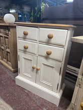 Load image into Gallery viewer, A charming two-tone cream cupboard offering practical storage with character. This piece features four small drawers positioned above a spacious double cupboard, making it ideal for hallways, bathrooms, or bedrooms. Structurally sound and in good working order, it bears the gentle patina of age with minor surface marks that add to its vintage appeal. A versatile addition to homes seeking functional, characterful furniture.
Delivery Available
Overall Dimensions
63cm wide x 25cm deep x 86cm high