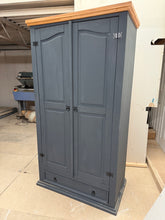 Load image into Gallery viewer, This pine wardrobe has been painted in 'Railings' by Farrow & Ball. Although it may have minimal marks, these can easily be remedied. Featuring 1 hanging rail, 1 shelf, and 1 long drawer, this wardrobe offers ample storage space for all your clothing needs.
Overall Dimensions
102cm wide x 56.5cm deep x 189cm high
DELIVERY AVAILABLE    
For our other items see our website https://fossewayfurniture.co.uk
collection from cv36 or bs36