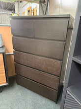 Load image into Gallery viewer, A classic black IKEA Malm chest offering practical storage with two shallow drawers and four deep drawers below. Structurally sound and in good condition with minor cosmetic marks that don't detract from its functionality. The clean lines and neutral finish make it an ideal fit for contemporary bedroom schemes. Ideal for maximising bedroom space without compromising on style.
Delivery Available
Overall Dimensions
81cm wide x 48.5cm deep x 123cm high 