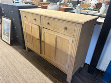 Load image into Gallery viewer, Embrace the raw elegance of this magnificent oak sideboard, stripped to reveal its pristine character. With two expertly crafted dovetail jointed drawers and a generous double cupboard featuring internal shelving, you'll enjoy ample room for all your storage needs. A simple wax finish will enhance and protect the wood, allowing you to create a bespoke piece that's uniquely yours.
Overall Dimensions
126cm wide x 50cm deep x 92cm high
DELIVERY AVAILABLE
For our other items see our website https://fo