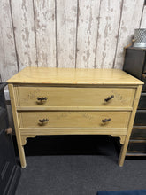 Load image into Gallery viewer, Vintage Art Deco chest of drawers with authentic character and solid construction. Features two spacious dovetail-jointed drawers ideal for bedroom or living room storage. Shows gentle signs of use with minor marks and dints but nothing major.
Delivery Available
Overall Dimensions
89cm wide x 46cm deep x 77cm high 