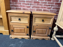 Load image into Gallery viewer, A practical pair of pine bedside tables, both in solid working condition with characterful patina from use. Each unit features one drawer and one cupboard, providing ample storage for essentials. Minor surface marks reflect their history, but structurally sound and ready for a new home.
Delivery Available
Overall Dimensions
44.5cm wide x 40cm deep x 61cm high 