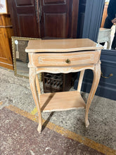 Load image into Gallery viewer, A charming limed side table that brings warmth and character to any bedroom or living space. Featuring a sturdy construction and thoughtful design, this piece offers practical storage with a convenient drawer and lower shelf—perfect for keeping essentials within easy reach. Its timeless finish and compact size make it an ideal companion for your bedside or as a stylish accent table.
Overall Dimensions
48cm wide x 31cm deep x 72cm high
DELIVERY AVAILABLE
For our other items see our website https://