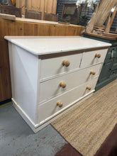 Load image into Gallery viewer, This beautiful wooden chest of drawers is coated in a vibrant white by its original owners, so would require touching up or a fresh coat of paint. It features two short dovetail jointed drawers above two longer ones for ample storage. Despite a crack along one side, this item is structurally strong and can easily be repaired.
Overall Dimensions
107cm wide x 50cm deep x 78.5cm high
DELIVERY AVAILABLE      
For our other items see our website https://fossewayfurniture.co.uk
collection from our shop at cv