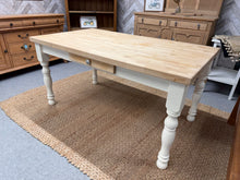Load image into Gallery viewer, This charming solid pine dining table features a white-painted finish with a natural top and drawer front. It comfortably seats six people and has removable legs for easier transport. While there are a few minor marks on the surface, they don’t detract from its overall appeal.
Overall Dimensions
152cm long x 86cm wide x 76cm high
DELIVERY AVAILABLE      
For our other items see our website https://fossewayfurniture.co.uk
collection from our shop at CV36 4QZ or purchase online for delivery.