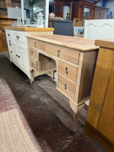 Load image into Gallery viewer, A beautiful stripped oak desk that combines solid construction with timeless appeal. The natural bare wood finish showcases the grain and character of quality oak, ready for your personal touch with wax or oil. The classic leather inlay adds sophistication, showing only minor wear. Six generously proportioned dovetail-jointed drawers provide ample storage for your workspace essentials.
Delivery Available
Overall Dimensions
109cm wide x 48cm deep x 76.5cm high 