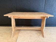 Load image into Gallery viewer, This beautiful stripped pine table showcases the wood's natural grain and character. Disassembles for convenient transport and comfortably seats up to six guests. Currently in good structural condition with a sound frame. The bare wood finish may benefit from a protective wax coat to enhance durability and appearance. An ideal centrepiece for rustic and country-style dining spaces.
Delivery Available
Overall Dimensions
122cm long x 68cm wide x 74cm high