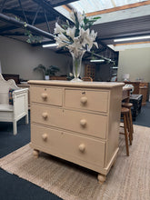 Load image into Gallery viewer, A charming vintage pine chest of drawers with authentic character. Hand-painted in soft baby pink and beige tones by previous owners, it shows gentle patina that adds to its period appeal—ideal for those who love the shabby-chic aesthetic or as a blank canvas for your own creative refresh. Features two short dovetail-jointed drawers above two spacious long drawers, offering practical storage with traditional craftsmanship. Structurally sound and in good overall condition. Includes two original keys. Perfect