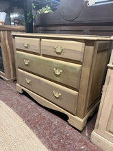Load image into Gallery viewer, This stripped satinwood chest of drawers reveals beautiful natural grain throughout. Completely bare wood, it's ready for your chosen finish—a protective wax coat is recommended. The piece features two short dovetail-jointed drawers above two generous long drawers, offering versatile storage. One drawer has a minor surface crack that doesn't impact functionality. A characterful vintage piece with solid joinery and timeless appeal.
Delivery Available
Overall Dimensions
105cm wide x 43cm deep x 81cm high&n