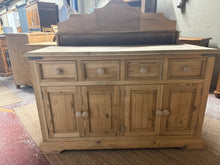 Load image into Gallery viewer, A charming solid pine sideboard in natural finish, ready for your personal touch. Features four shallow drawers positioned above two single cupboards, offering versatile storage for dining rooms, hallways, or living spaces. The stripped-back wood showcases authentic grain and character. We recommend applying a protective wax finish to enhance durability and bring out the natural beauty of the pine. Door handles can be easily upgraded as these ones catch when closing.
Delivery Available
Overall Dimensions