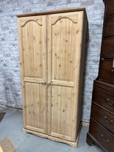 Load image into Gallery viewer, Expertly restored to reveal its true beauty, this solid pine wardrobe is sure to make a statement in your home. With one hanging rail for convenient storage, it's perfect for keeping your clothes organized and accessible.
Overall Dimensions
90cm wide x 53cm deep x 179cm high
DELIVERY AVAILABLE      
For our other items see our website https://fossewayfurniture.co.uk
collection from our shop at cv36, our collection zone at bs36 or otherwise delivery is available