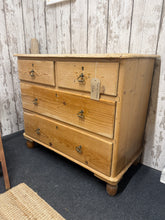 Load image into Gallery viewer, This charming vintage pine chest of drawers combines authentic character with practical storage. Structurally sound and in good overall condition, it features a classic 2+2 drawer configuration—two shallow drawers above two generous deep drawers—ideal for bedroom or hallway use. As a pre-loved piece, it bears the honest patina of age with minor surface marks and wear to one drawer, adding to its rustic appeal. Perfect for country, farmhouse, or eclectic interiors seeking genuine vintage charm and functional