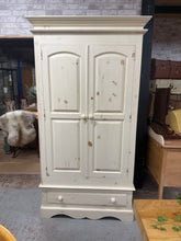 Load image into Gallery viewer, A charming solid pine wardrobe in good working condition. This pre-loved piece features a sturdy hanging rail for your clothes and a spacious dovetail-jointed drawer for additional storage. Minor surface marks reflect its character and use. Designed for practicality, it disassembles into three sections for convenient transport and repositioning. Ideal for adding warmth and functionality to any bedroom.
Delivery Available
Overall Dimensions
107cm wide x 62cm deep x 200cm high