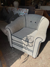 Load image into Gallery viewer, A charming armchair featuring classic grey and navy fabric upholstery, resting on castors for easy repositioning. Dating from the early-to-mid 20th century, this piece boasts solid structural integrity with only minor cosmetic marks that add to its authentic character. The comfortable seating and timeless design make it an ideal focal point for any living room, bedroom, or study space.
Delivery Available
Overall Dimensions
approx : 80cm wide x 84cm deep x 80cm high 