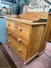 Load image into Gallery viewer, A well-preserved vintage pine chest of drawers with four generously proportioned drawers—two compact upper drawers and two larger lower ones—all featuring authentic dovetail joints. The piece remains structurally reliable and fully functional. Its weathered surface carries the natural patina of age; whilst some marks are permanent fixtures of its history, others will fade with careful polishing. An honest, characterful addition to period or eclectic interiors.
Delivery Available
Overall Dimensions
91cm w