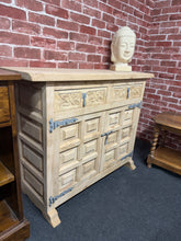 Load image into Gallery viewer, A striking Spanish sideboard in solid hardwood, stripped to reveal its natural grain and character. The piece features two dovetail-jointed drawers positioned above a double cupboard with internal shelf, providing generous storage for dining rooms or living spaces. Currently in bare wood finish—a light coat of wax will enhance protection and bring out the wood's warmth. An authentic statement piece with timeless appeal.
Delivery Available
Overall Dimensions
100.5cm wide x 37cm deep x 80cm high