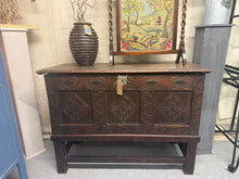 Load image into Gallery viewer, A handsome oak coffer in great structural condition, showing gentle patina befitting its age. The hinged lid opens to generous storage space, making it both a striking focal point and a practical addition to any room. Minor age-related marks enhance its authentic character.
Delivery Available
Overall Dimensions
114cm wide x 49cm deep x 82.5cm high 