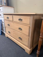 Load image into Gallery viewer, A characterful satinwood chest of drawers with solid construction and vintage patina. Features two short dovetail-jointed drawers above two generous long drawers, offering practical storage with traditional craftsmanship. The bare wood finish showcases the natural grain—a light wax coat will enhance its beauty and protection. Some surface marks and a minor side crack reflect its age, but the piece remains fully functional and structurally sound. Ideal for those who appreciate period furniture with genuine h