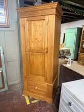 Load image into Gallery viewer, A practical single wardrobe crafted from solid pine, offering reliable storage for everyday use. This pre-loved piece shows its age with minor surface marks, yet remains structurally solid and fully functional. Inside, you'll find a hanging rail for garments, an internal shelf for folded items, and a dovetail-jointed drawer for additional storage. Ideal for bedrooms or compact spaces.
Delivery Available
Overall Dimensions
82cm wide x 61cm deep x 193cm high 
