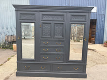 Load image into Gallery viewer, This beautiful large compactum wardrobe is finished in a stylish ash black paint. It’s pre-owned with only a few minor marks, nothing significant. This eye-catching piece is sure to be the talking piece of your room. Offering plenty of storage, it features five dovetail-jointed drawers, a cupboard with a hanging rail and hooks, another cupboard with three makeshift shelves, and a smaller cupboard with an additional shelf. For easy relocation, it breaks down into five parts.
Overall Dimensions
224cm wide x