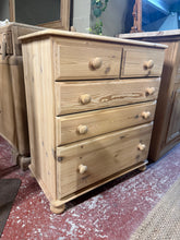 Load image into Gallery viewer, A beautiful solid pine chest of drawers, stripped back to reveal the natural wood grain. Features two short drawers over three spacious long drawers, offering generous storage for any room. The piece is in excellent condition and structurally sound. The natural finish allows the wood's character to shine through, though a protective coat of wax is recommended to enhance durability and appearance.
Delivery Available
Overall Dimensions
75cm wide x 40cm deep x 86cm high