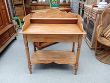Load image into Gallery viewer, A charming solid pine washstand with authentic character. Structurally sound and ready for use, this piece features a practical lower shelf ideal for storage or display. Whether you're seeking a vintage sink unit or a distinctive entryway table, this washstand adapts beautifully to your needs. As a pre-loved item, it bears gentle signs of age and use that add to its rustic appeal.
Delivery Available
Overall Dimensions
86.5cm wide x 46cm deep x 89cm high 