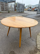 Load image into Gallery viewer, This beautiful blonde mid-century Ercol dining table is solidly built and well-maintained. It shows only slight marks that are hardly visible. Easily extendable, it comfortably accommodates 4 to 5 people.
Delivery Available
Overall Dimensions
103cm x 62cm x 71cm high 
126cm extended      