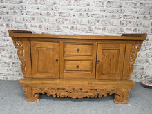 Load image into Gallery viewer, This beautiful Indonesian carved sideboard is sturdy and generally well-preserved. While there are a few marks on the top and some minor wear on the skirt, these do not detract from its charm. It offers plenty of storage space with two dovetail-jointed drawers and two cupboards, each featuring a shelf. This piece is sure to brighten up any room and become a standout feature.
Overall Dimensions
161cm wide x 60.5cm deep x 89cm high
DELIVERY AVAILABLE      
For our other items see our website https://fosse