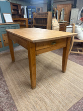 Load image into Gallery viewer, Constructed with durable solid wood, this dining table maintains its structural integrity and remains in good condition, despite its age. The top has been replaced with oak by the previous owners, creating a beautiful contrast with the antique pine legs. Additionally, it offers storage with one drawer.
Overall Dimensions
129cm long x 76cm wide x 76cm high
DELIVERY AVAILABLE    
For our other items see our website https://fossewayfurniture.co.uk
collection from cv36 or delivery available
