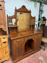 Load image into Gallery viewer, This charming mahogany sideboard is solidly built and remains in good overall shape. It shows some light signs of use, but nothing significant. With three short drawers featuring dovetail joints above two single cupboards each with a shelf, it provides generous storage. The top can be removed from the base, making it easier to transport.
Overall Dimensions
133cm wide x 48cm deep x 190cm high
DELIVERY AVAILABLE
For our other items see our website https://fossewayfurniture.co.uk
collection from our