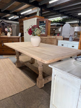 Load image into Gallery viewer, Crafted from solid oak and stripped back to reveal its natural character, this refectory dining table makes a striking focal point for any dining space. The authentic patina and gentle age marks add genuine vintage charm—a coat of wax will enhance the finish and provide protection.
Designed to comfortably seat 8 people, it's perfect for family gatherings and entertaining. The removable top means you can easily transport and rearrange the table when needed. A timeless statement piece that brings warmth and p