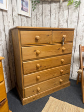 Load image into Gallery viewer, A charming solid pine chest of drawers with classic proportions and practical storage. Features two short dovetail-jointed drawers above four longer drawers, offering versatile space for bedroom or living room organisation. The piece shows character through its patina and minor surface marks, which add to its authentic appeal. Structurally sound and ready to use immediately. A timeless addition to any home.
Delivery Available
Overall Dimensions
91cm wide x 49cm deep x 104cm high