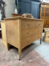 Load image into Gallery viewer, A beautiful mahogany chest of drawers, stripped to reveal its natural grain and warm tones. Features two short dovetail-jointed drawers above two spacious long drawers, offering versatile storage. The solid construction shows character marks consistent with vintage pieces. Bare wood finish allows you to personalise with wax or oil to suit your décor. Fitted with castors for convenient repositioning. Structurally sound and ready to become a cherished centrepiece in any room.
Delivery Available
Overall Dime
