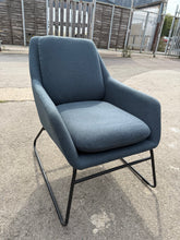 Load image into Gallery viewer, This navy blue armchair offers a perfect blend of sturdiness and practicality, remaining in excellent condition overall. It shows minor wear in a few spots, but nothing significant. The detachable legs make moving it around hassle-free and convenient.
Delivery Available
Overall Dimensions
approx : 63cm wide x 74cm deep x 82cm high 