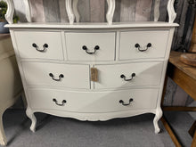 Load image into Gallery viewer, A charming white French-inspired chest of drawers that combines timeless elegance with practical storage. Featuring six generously sized drawers—three compact, two mid-sized, and one spacious—this piece offers versatile organisation for any room. While showing gentle signs of use with minor surface marks, the sturdy construction ensures reliable everyday use. Perfect for adding classic French sophistication to your bedroom or living space.
Delivery Available
Overall Dimensions
120cm wide x 42cm deep x 96