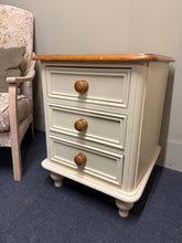 Load image into Gallery viewer, A charming two-tone bedside table with authentic country character. Structurally sound and in good overall condition, this piece shows gentle signs of use consistent with its vintage appeal. Features three dovetail-jointed drawers offering practical storage for bedside essentials. Perfect for adding warmth and character to a bedroom.
Delivery Available
Overall Dimensions
50.5cm wide x 50cm deep x 64cm high 