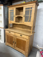 Load image into Gallery viewer, This beautiful antique pine dresser is sturdy and remains in great condition overall. Its small age-related marks only add to its delightful character. It provides generous storage with two cupboards in the top section, two dovetail-jointed drawers beneath, and a large double cupboard at the base. Plus, it can be separated into two pieces for easier transportation.
Overall Dimensions
141.5cm wide x 59cm deep x 201cm high
DELIVERY AVAILABLE      
For our other items see our website https://fossewayfurnit