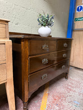 Load image into Gallery viewer, A mahogany chest of drawers in good working order. The piece shows honest signs of use with surface marks that should respond well to polishing. Featuring a practical 2+2 drawer configuration—two short drawers above two long drawers—offering versatile storage for bedrooms or living spaces. Smooth-rolling castors make repositioning effortless. An authentic vintage find with character and functionality.
Delivery Available
Overall Dimensions
103.5cm wide x 45.5cm deep x 79cm high + 6cm 