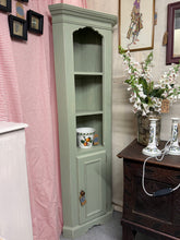 Load image into Gallery viewer, A charming sage green corner unit with authentic distressed detailing. Sturdy construction and well-maintained throughout. Features two open shelves above a single-shelf cupboard, providing generous storage for display and everyday items. The soft, muted tone complements both traditional and contemporary interiors, making it a versatile addition to any room.
Delivery Available
Overall Dimensions
approx : 59cm wide x 32cm deep x 180cm high