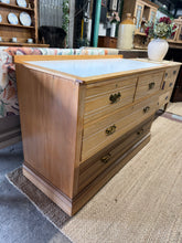 Load image into Gallery viewer, A characterful satinwood chest of drawers in sound structural condition. Features two short dovetail-jointed drawers above two long drawers, offering practical storage. The removable laminate top makes it ideal for conversion to a washstand. One drawer requires minor attention, and there is minor corner damage consistent with use. A versatile piece with genuine period appeal.
Delivery Available
Overall Dimensions
124cm wide x 52.5cm deep x 82cm / 86cm high 
