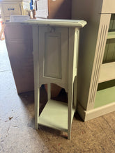 Load image into Gallery viewer, A charming vintage-style plant stand crafted from solid wood with plenty of character. The soft light green finish adds a gentle, botanical touch to any room. It is used and has marks so could do with a refresh.
Delivery Available
Overall Dimensions
28cm wide x 28cm deep x 75cm high