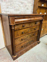 Load image into Gallery viewer, A magnificent mahogany chest of drawers offering exceptional storage potential with its thoughtfully designed layout of two short dovetail-jointed drawers, three spacious long drawers, and a charming secret compartment. Built to last with solid construction and structural integrity, this piece showcases the character and warmth of genuine mahogany wood. While bearing the gentle patina of age and use, it remains in commendable condition, ready to bring timeless elegance and practical functionality to any roo