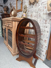 Load image into Gallery viewer, Elegant oval wooden wine rack with capacity for 14 bottles. Structurally sound and in good condition, this statement piece adds character to any space. Shows minor marks consistent with its vintage charm.
Delivery Available
Overall Dimensions
42cm wide x 29cm deep x 87cm high 